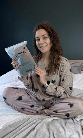 Person smiling with a product on a couch